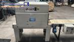 Automatic L-sealer with shrink tunnel.