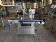Automatic self-adhesive labeling machine for cylindrical bottles