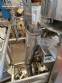 Vertical wrapping machine for triangular format