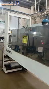 Labeling machine with steam sleeve tunnel and bottle baler