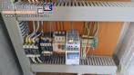 Labeling machine with steam sleeve tunnel and bottle baler