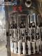 Zegla rotary filling machine with rinser and three-block capping system.